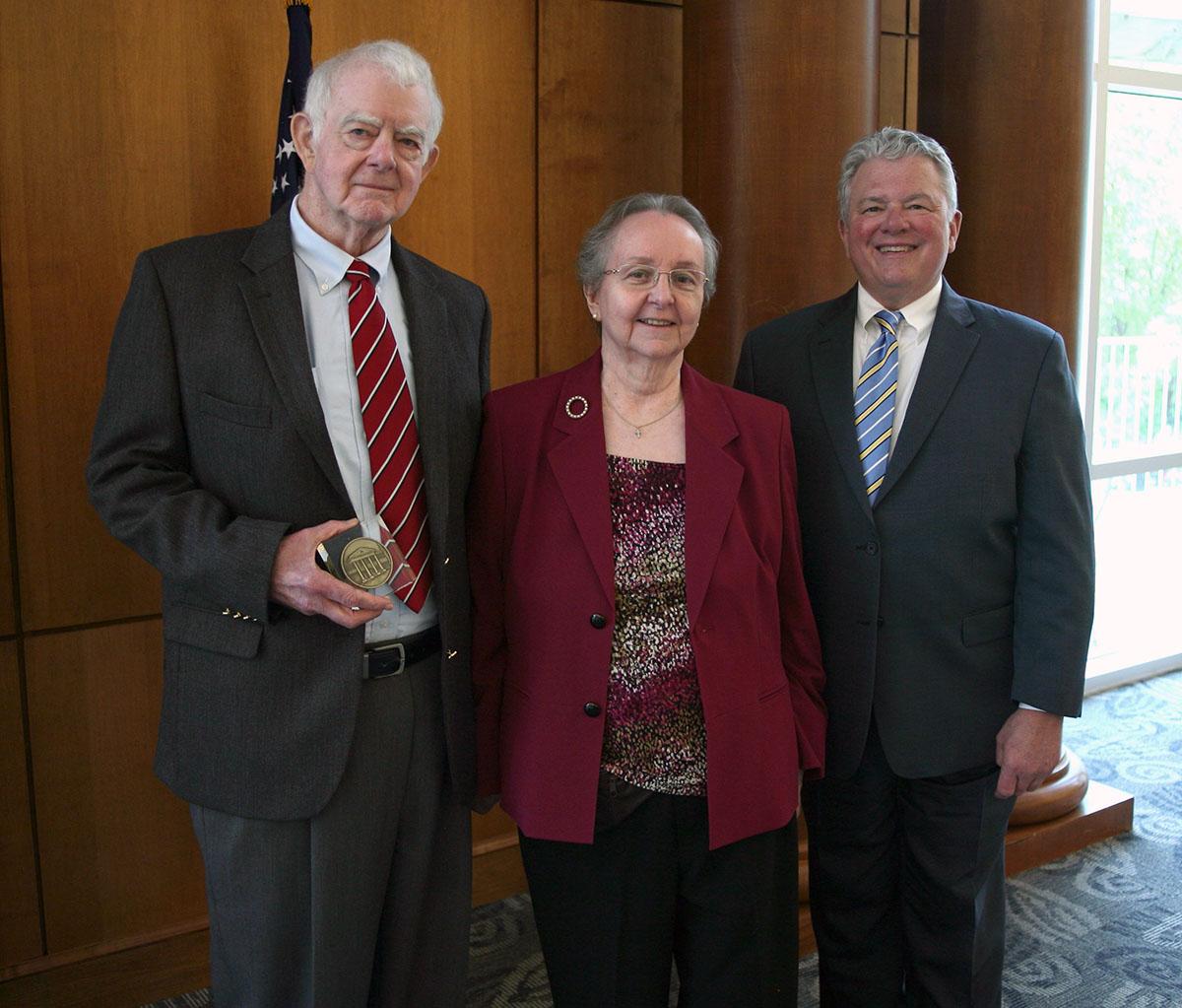 LC President Dan McAlexander, left, with Bruce and Emily Herrington.
